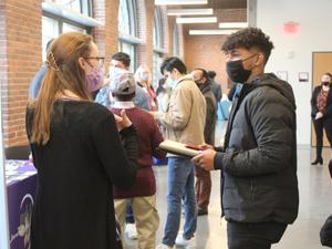 students at career fair speaking to employers